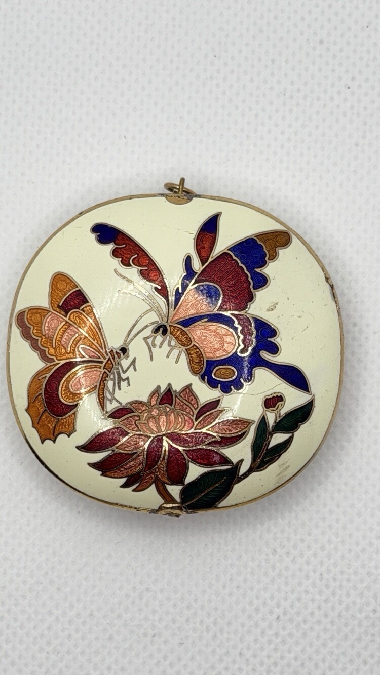 A vintage cloisonné enamel pendant with lotus and butterfly motifs.